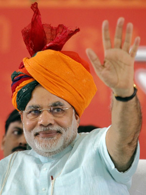 Gujarat’s CM Modi wears traditional Indian turban as he waves to his supporters on second day of his fast in Ahmedabad