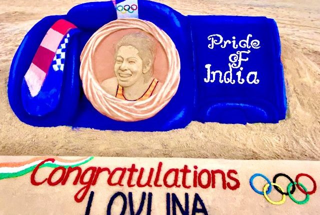 Sudarsan Pattnaik creates 10ft long sand glove, congratulating Lovlina Borgohain for winning bronze medal for India.