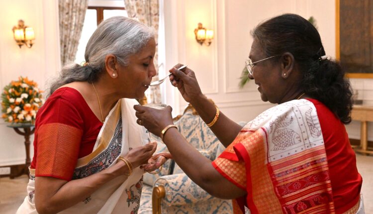 President Droupadi Murmu ceremonially offers Union Finance Minister Nirmala Sitharaman the traditional 'dahi-cheeni' (curd and sugar) in anticipation of her Budget presentation.